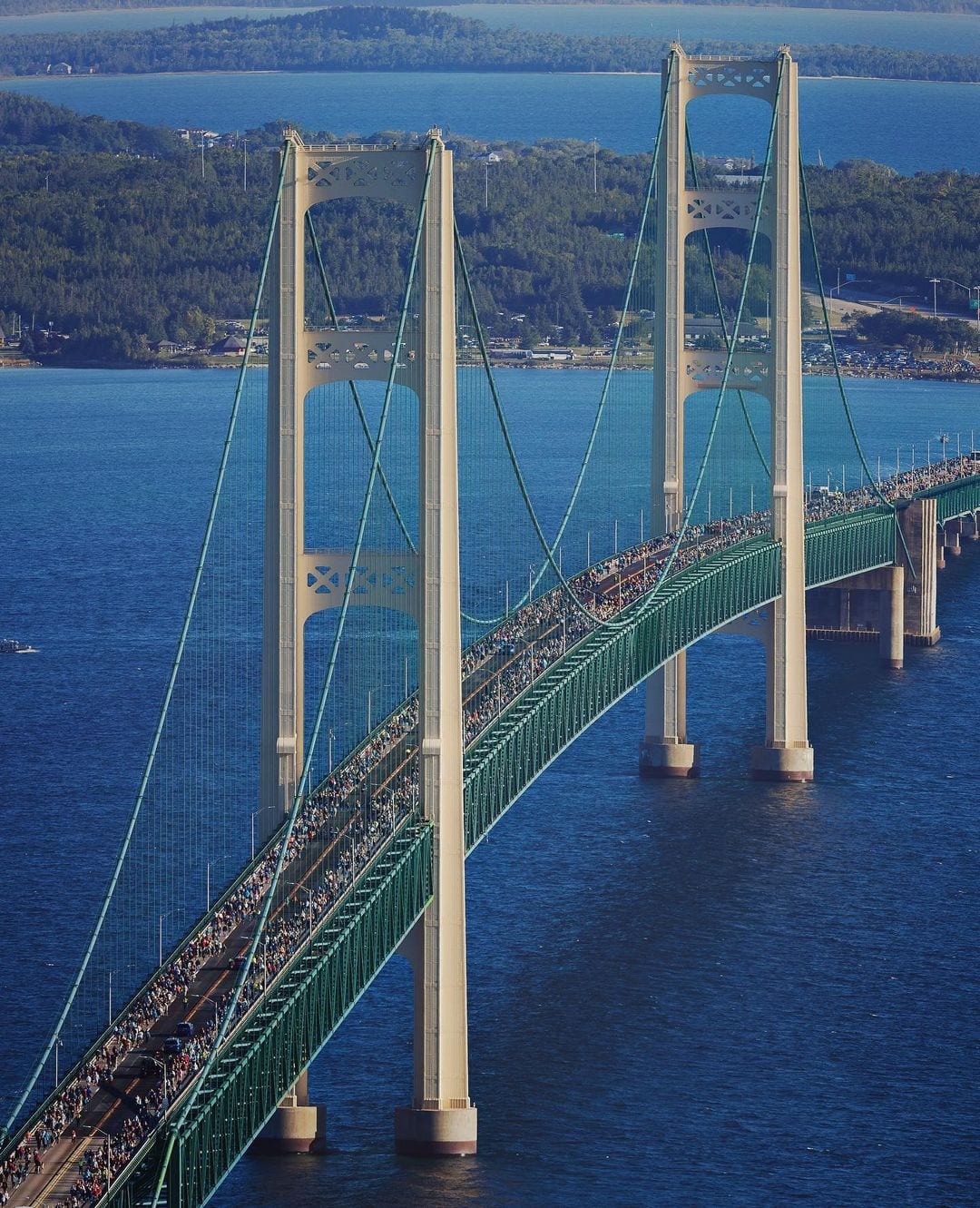 Aerial view of the Mackinac Bridge during the Labor Day Bridge Walk, the deck full of people crossing on foot